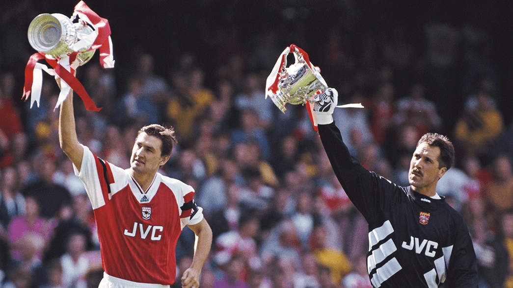 Tony Adams and David Seaman lift the FA Cup and League Cup