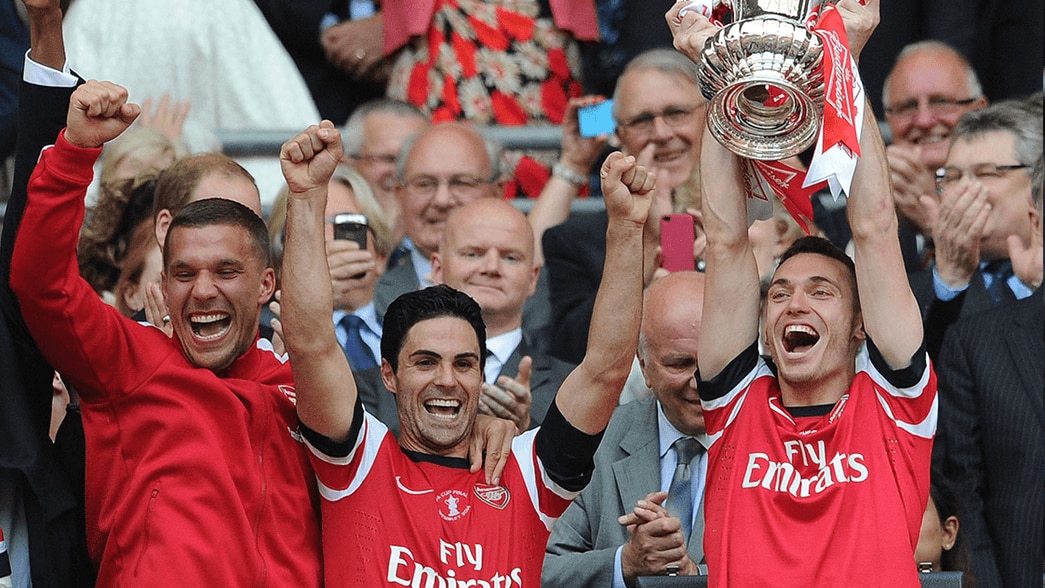 Mikel Arteta, Lukas Podolski and Thomas Vermaelen celebrate winning the FA Cup in 2014
